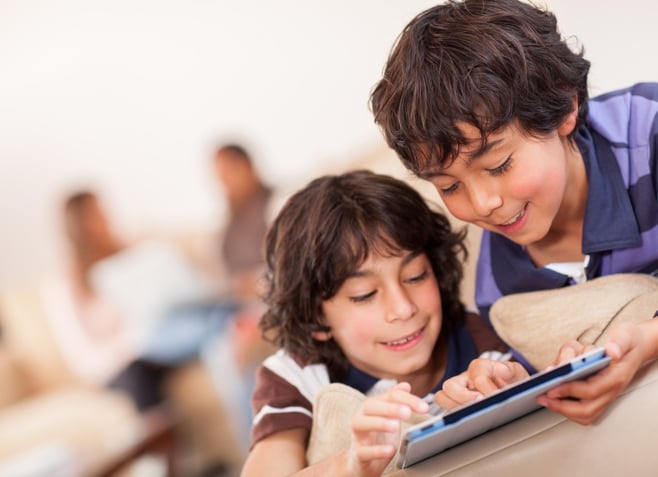 Happy boys playing with a tablet computer.jpeg